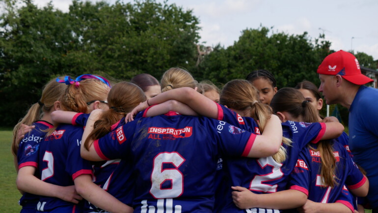 Team in a huddle with a coach